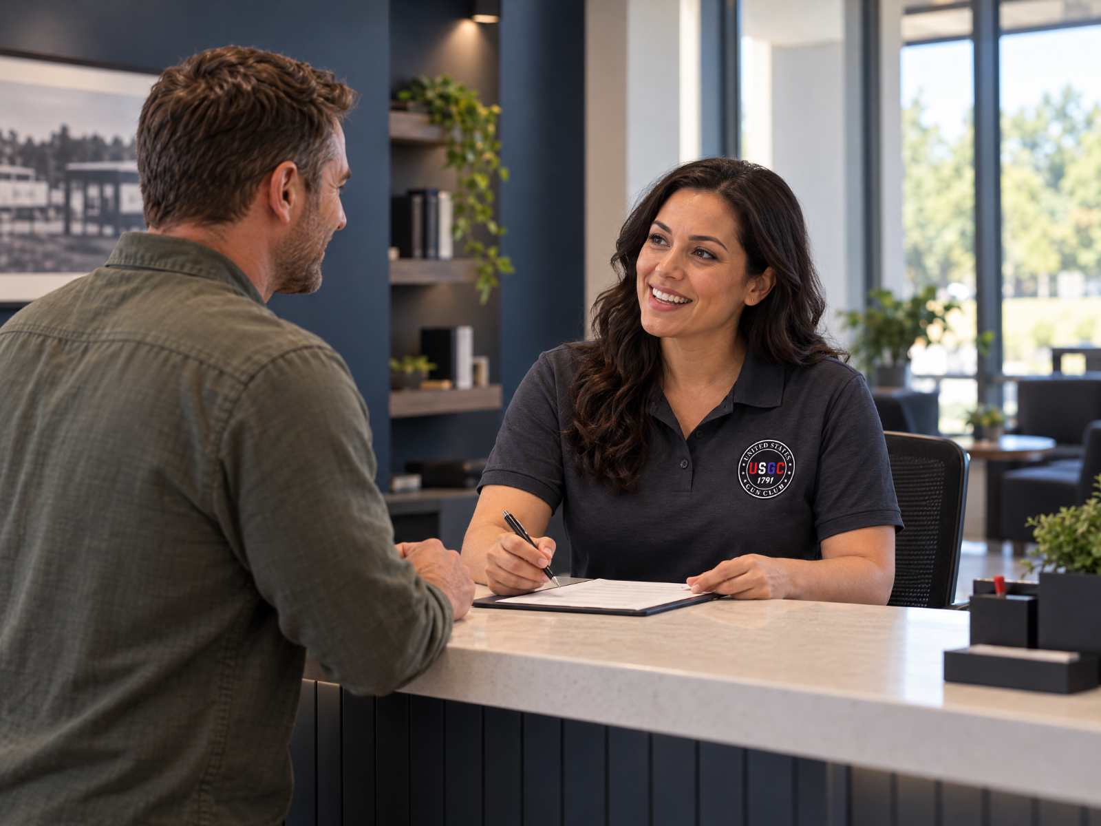 USGC representative assisting a visitor at a service desk.